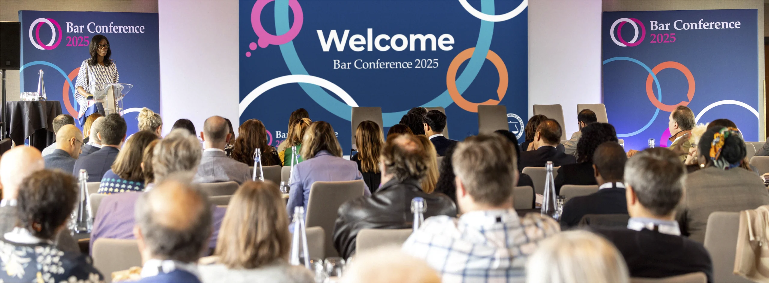 A speaker at the Bar Council 2025 conference, event large format design and print.