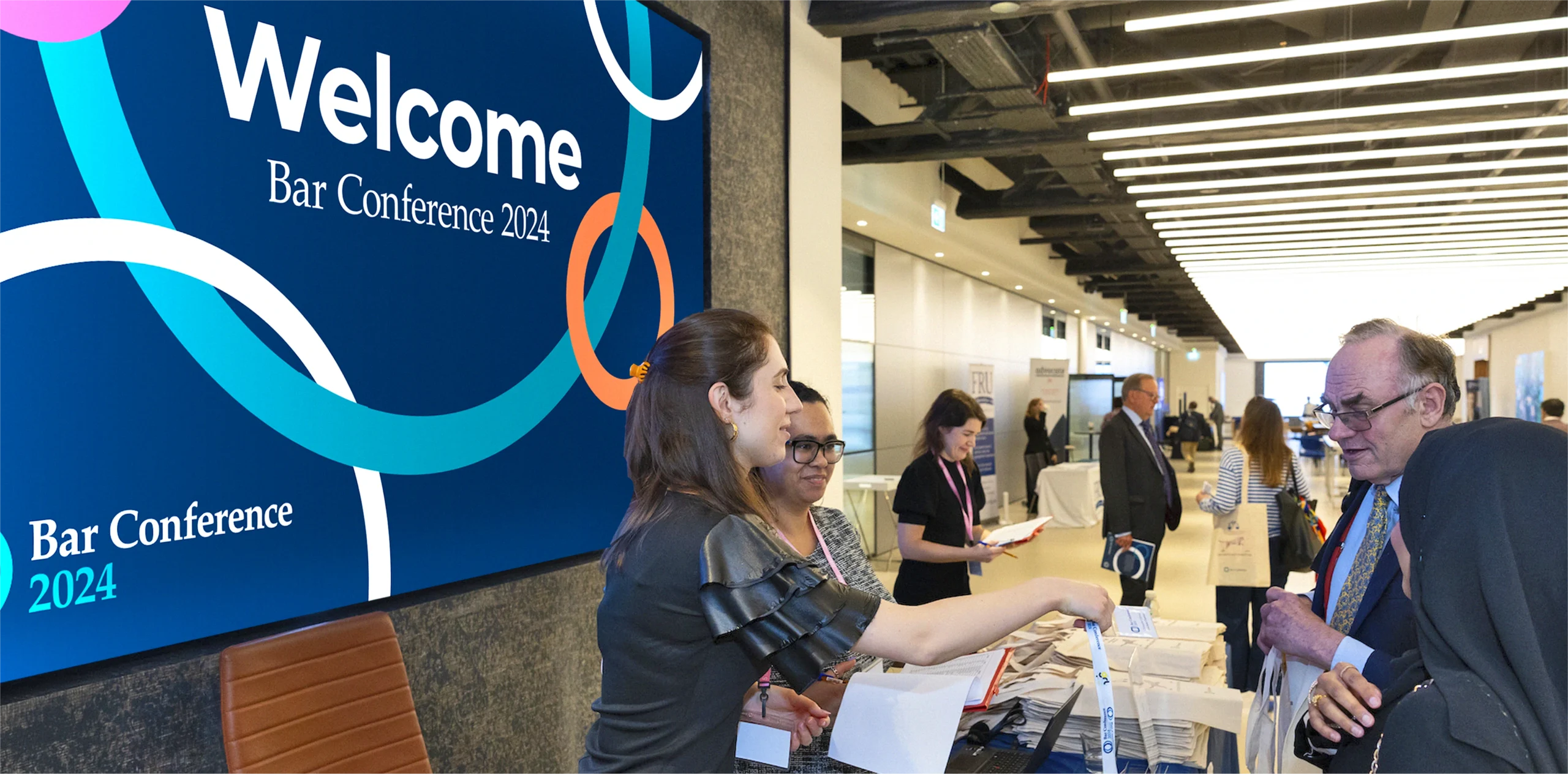 Event photography showing Bar Council 2024 branding with digital screen.