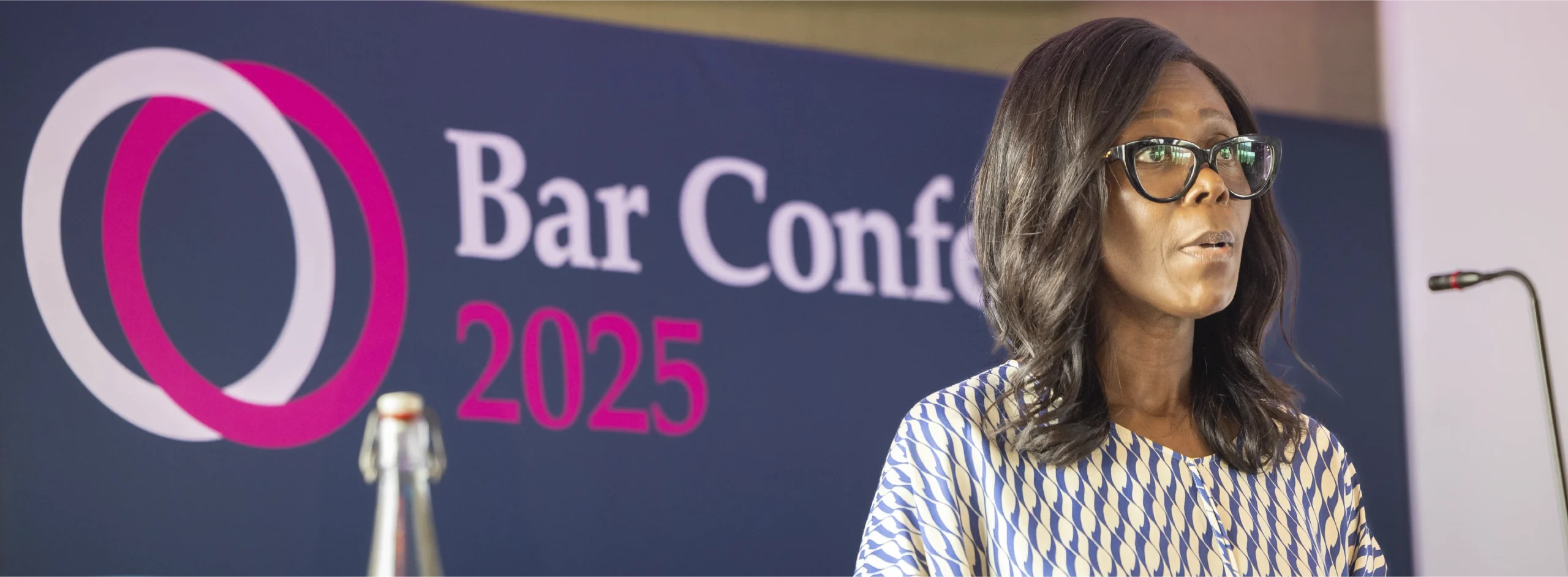 Keynote speaker in front of Bar conference 2025 event graphics.