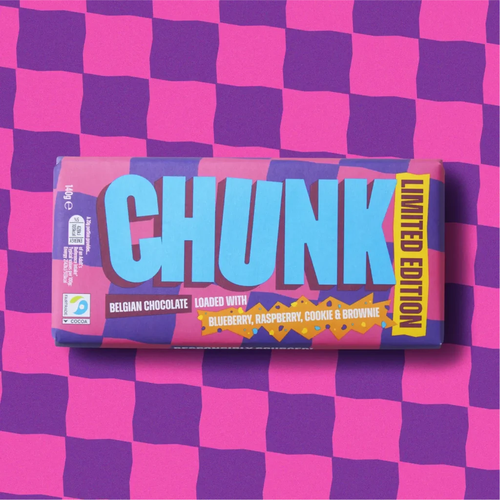 Blueberry, Rasberry, Cookie & Brownie Limited Edition Chunk chocolate bar photographed on top of a wavy pink and purple chequerboard pattern