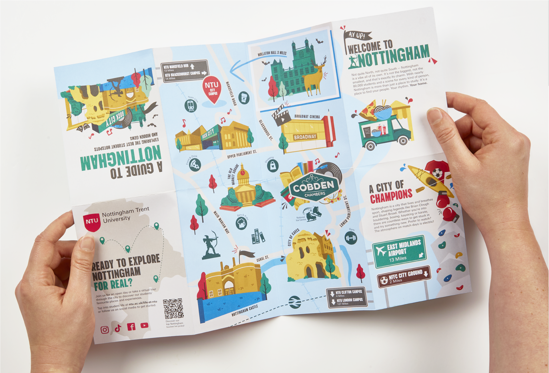 Hands holding a printed fold out guide to Nottingham. Designed illustrated and printed for Nottingham Trent University.